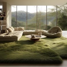 a living room filled with lots of furniture and green carpeted floor to ceiling windows