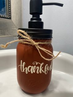 a brown mason jar sitting on top of a white sink