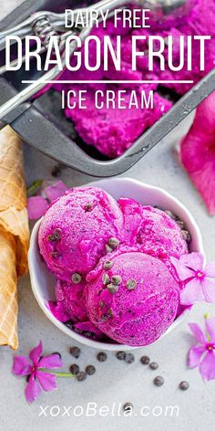 dairy - free dragon fruit ice cream in a bowl with flowers and spoons next to it