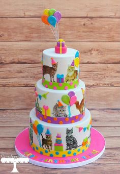 a three tiered cake with cats and balloons on the top is decorated in bright colors