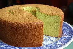 a cake on a blue and white plate with a slice missing