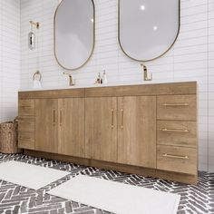 a bathroom with two sinks and three mirrors on the wall above them is tiled flooring