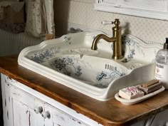 a white sink sitting on top of a wooden counter