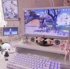 there is a computer monitor and keyboard on the desk with anime figurines next to it