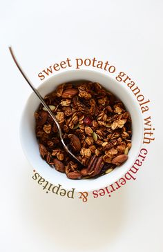 a bowl filled with granola sitting on top of a white table