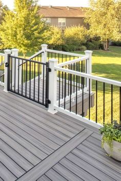 a white deck with black railing and planter