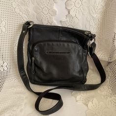 Vintage 2000's Y2K genuine Black leather shoulder/crossbody bag. The brand is *FOSSIL*. Has numerous compartments. Outside on one side there is a large flap compartment and a zippered pocket. The other side has a small slip pocket and a zippered pocket that credit cards and money can be stored in. The main inside compartment has 2 small slip pockets and a zippered pocket. The shoulder strap is adjustable. *SCROLL DOWN FOR CONDITION & MEASUREMENTS* CONDITION: I note one tiny abrasion on the front of the bag below where it reads: FOSSIL (SEE PIX). MEASURES: Height excluding strap~11" Width~11" Adjustable strap *WE APOLOGIZE~BUT WE NO LONGER SHIP TO GERMANY, ITALY OR SPAIN. IF ORDERS COME IN FROM GERMANY, ITALY OR SPAIN, WE WILL HAVE TO CANCEL THEM AND REFUND YOUR MONEY. SORRY FOR THIS INCONV Uni Bag, Y2k Shoulder Bag, Small Crossbody Purse, Cross Bag, Leather Silver, Small Crossbody Bag, Black Cross Body Bag, Crossbody Purse, Credit Cards