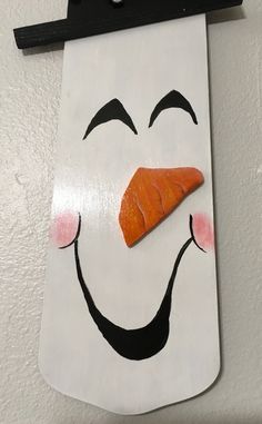 a sign with a carrot sticking out of it's mouth