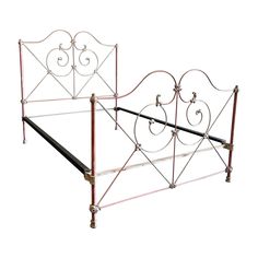 a metal bed frame with pink and white designs on the headboard is shown in front of a white background