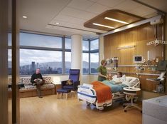 two people in a hospital room with an open window