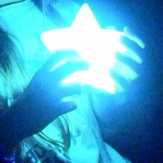 a person holding a glowing star in their hand