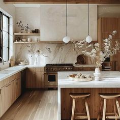 a kitchen with wooden cabinets and white counter tops next to an island in the middle