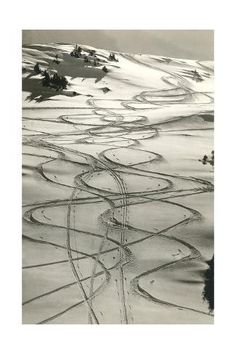 an aerial view of snow covered hills and roads