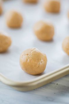 doughnuts on a baking sheet ready to go into the oven for making cookies