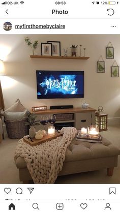 a living room filled with furniture and a flat screen tv on top of a wall