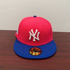 a new york yankees hat sitting on top of a wooden table