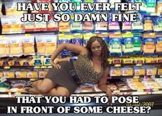 a woman posing in front of a display of food at a grocery store with her legs on the ground