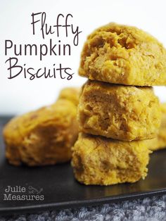 three puffy pumpkin biscuits stacked on top of each other with the words fluffy pumpkin biscuits above them