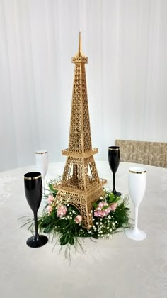 the eiffel tower is decorated with flowers and wine glasses