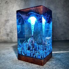 a glass block with an image of a city in the center and lightning coming out of it