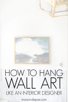 a white wall with the words how to hang a wall art like an interior designer