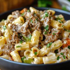 a bowl full of pasta with meat and vegetables