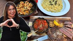 a woman making a heart shape with her hands in front of some food on the table