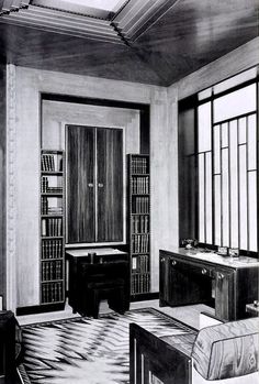 an old photo of a room with bookshelves and desks