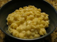 a bowl filled with macaroni and cheese on top of a counter