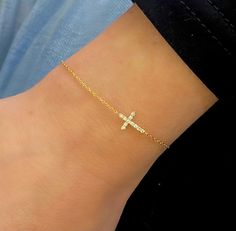 Our Esther Dainty Diamond Cross Bracelet is a glimmering beacon of faith. Stylish and elegant, this bracelet embodies the beauty of His grace. Perfect to shine on its own but sophisticated enough to add to a stack. The intentional delicacy of this design makes for the heartfelt gift of a child's first piece of fine jewelry or an adult's everyday dainty wear. Metal: 18k White Gold / 18k Yellow Gold / 18k Rose Gold Round Brilliant Cut Natural Diamonds: Approx. 0.10 ctw G Color and SI1-2 Clarity Diamonds Length: 7 inches at the longest. ﻿Adjustable sliding bead to provide options for smaller wrist size. Closure: Lobster clasp Measurements: Approx. 11.7mm length x 5.9mm width Looking for a different size? Please email us. Collar Chain, Mens Engagement, How To Make Rings, Bridal Bands, Diamond Cross, Jewelry Lookbook, Band Bracelet, Choker Collar, Cross Bracelet