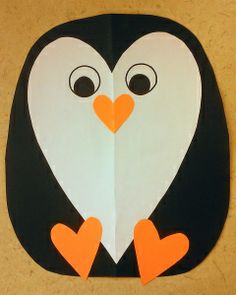 a paper cut out of a penguin with two hearts on it's chest and eyes