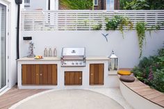 an outdoor kitchen with grill and seating area