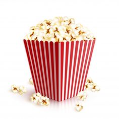 a red and white striped popcorn box with some popcorn scattered around it on a white background