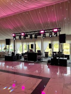 an empty dance floor with lights and sound equipment set up for a wedding or special event