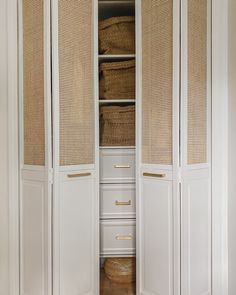 an open closet with wicker doors and drawers