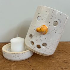 a white candle holder with two holes in it