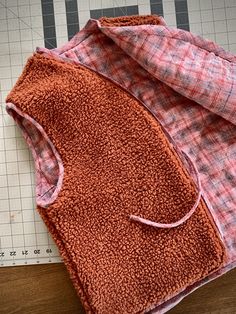 two towels laying on top of a cutting board