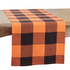 an orange and black checkered table runner