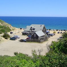 a beach with cars parked on the sand