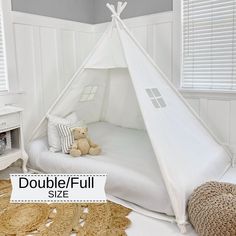 a white teepee bed with a teddy bear on it