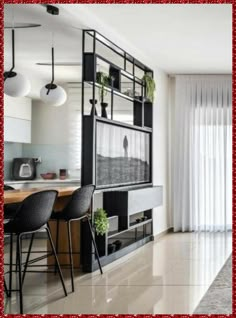 a living room filled with furniture and a flat screen tv mounted on a wall next to a window