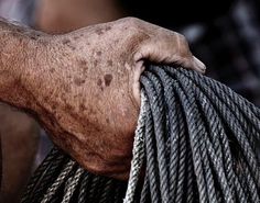 a man holding a rope in his left hand and pulling it on the other side