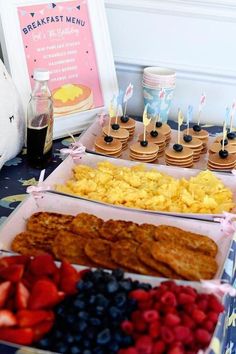 an assortment of breakfast foods displayed on a table