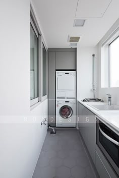 a washer and dryer are in the corner of an empty room with windows