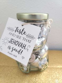 a jar filled with lots of buttons and a sign that says, faste and see that jehovan is good