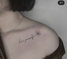 a woman's chest with the word love yourself written in cursive writing