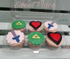 cupcakes decorated with different colored frosting on a tray