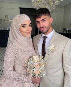 a man in a suit and woman in a wedding dress posing for a photo together