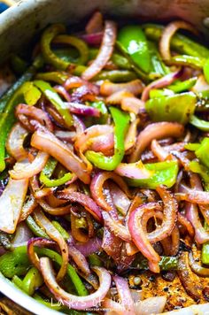 a pan filled with onions and green peppers