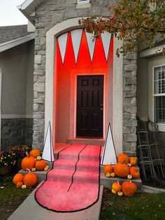 a house decorated for halloween with pumpkins and decorations